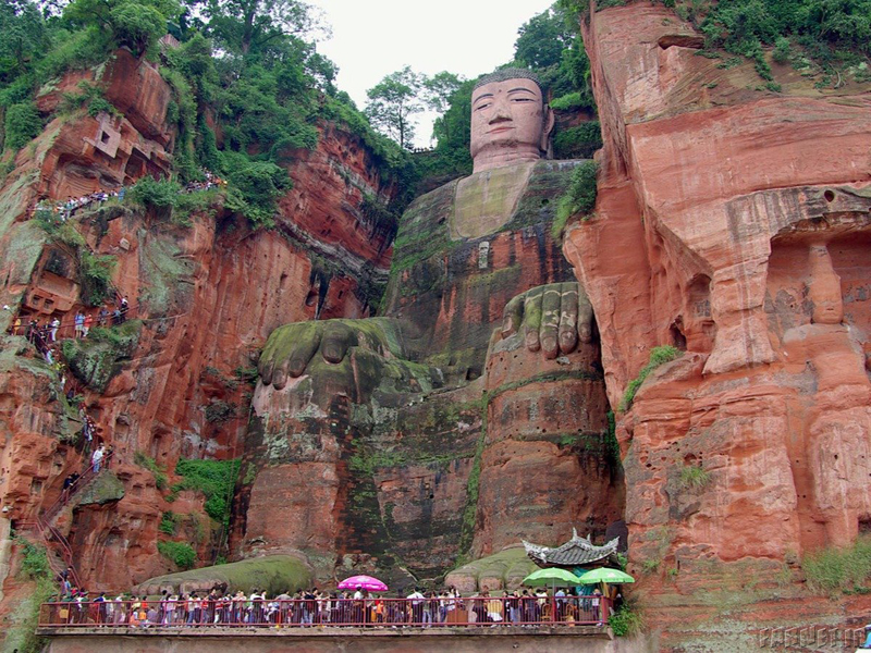 the-232-foot-high-leshan-giant-buddha-carved-on-the-hillside-of-the-xijuo-peak-overlooks-three-of-chinas-rivers-the-unesco-world-heritage-site-is-built-with-incredible-detail-over-a-thousand-buns-were-mad